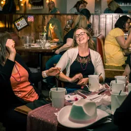 a group of people sitting at a table in a restaurant