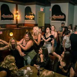 a group of people standing in front of a crowd posing for the camera