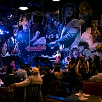 a group of people sitting on a stage in front of a crowd